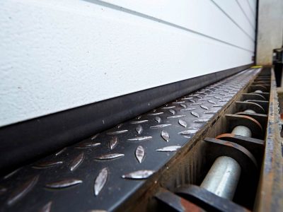 Montage einer eM-FLEX Spaltabdichtung SAMTS an einem Rolltor. Vorher: durchlässige Gummidichtung.